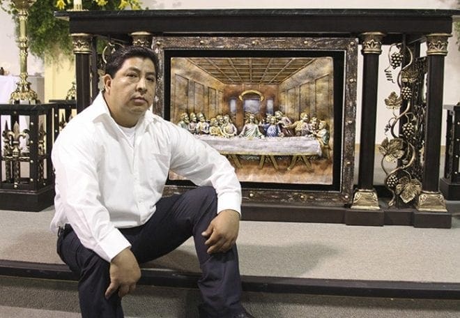 Mexican native Alfonso Juarez sits by the altar he made for the Cathedral of Christ the King Mission. It’s made of metal with a marble top. Photo By Michael Alexander