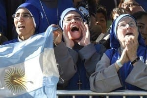 Nuns sing and wave the flag of Argentina as they wait for the parade with Pope Francis in Washington Sept. 23. (CNS Photo/John Beale)