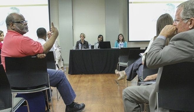 Two attendees dialogue during a workshop discussion on “Improving Health Outcomes in Spite Of Poverty.” Andy Miller of Georgia Health News moderated the panel that included (l-r, at table) Linda Lowe, GLSP health policy specialist, Jada Bussey-Jones, M.D., of Grady Memorial Hospital’s Primary Care Center and Emory University School of Medicine, and Kim Case, APRN, director of quality at Mercy Care. Photo By Michael Alexander