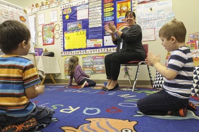 Prekindergarten lead teacher Amy Rivard, second from right, leads a song incorporating the months of the year with students (clockwise from bottom right) J.T. Melton, Luke Kepshire and Evangeline Crine. Photo By Michael Alexander