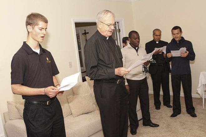 (L-r) Seminarian Dan Fitzgerald, senior priest Father Richard Morrow, seminarian Ainer Pena, Missionaries of St. Francis de Sales Father Joseph Mullakkara, parochial vicar at St. Benedict Church, Johns Creek, and seminarian Miguel Herazo follow the program of prayers and songs during the Nov. 2 blessing of the St. Charles Borromeo House, Atlanta. Photo By Michael Alexander