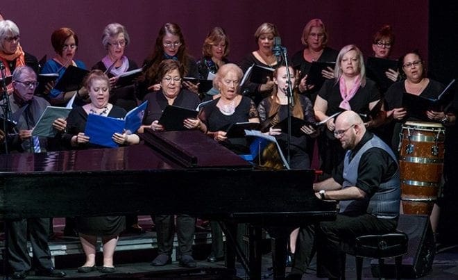 The Jubilee Choir from the Shrine of the Immaculate Conception, Atlanta, performed during the interfaith evening at the Ferst Center. Directed by Dónal P. Noonan, at the piano, the group ended the program with a rousing rendition of “Siyahamba/Marching in the Light of God.” Photo By Thomas Spink