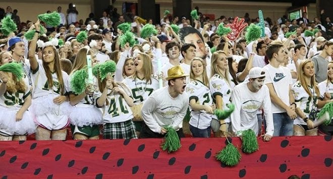 Senior Jon Anderson, front row, gold hat, cheers with others for the Blessed Trinity Titans after a second quarter touchdown during the Dec. 11 Class AAA state football championship against Westminster at the Georgia Dome, Atlanta. The touchdown gave the Titans a 10-6 lead, which they held to the end of the game’s first half. Photo By Michael Alexander