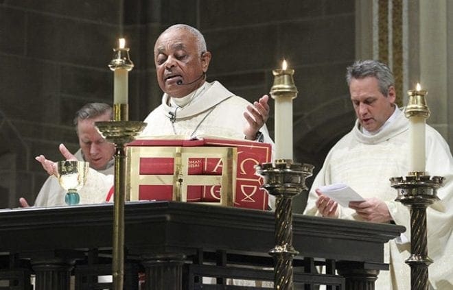 Father Neil Herlihy, left, pastor of St. Brigid Church, Johns Creek, and Father Brian Lorei, right, pastor of St. Stephen the Martyr Church, Lilburn, were two of the priests joining Archbishop Wilton D. Gregory around the Cathedral of Christ the King altar during the Liturgy of the Eucharist at the Jan. 22 Mass for the Unborn. Photo By Michael Alexander