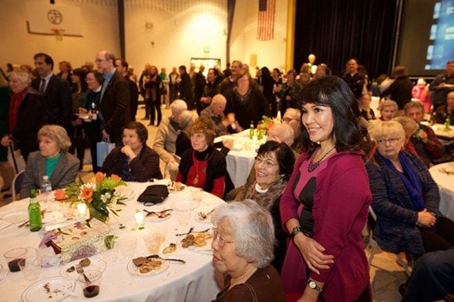 People from different parishes where Msgr. Paul Fogarty pastored over the decades enjoy the jokes of his priest colleagues at a reception following Mass. Photo By Dave Dawson