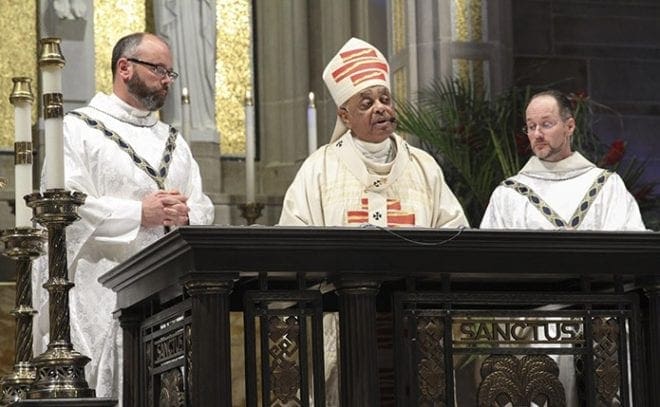 Archbishop Wilton D. Gregory, center, leads the incardination ceremony for Father Paul Moreau, left, parochial vicar at St. Joseph Church, Athens, and Father Patrick Scully, pastor of St. Peter’s Church, LaGrange, and St. Elizabeth Seton Mission, Warm Springs. Father Moreau transferred his allegiance from the Legionaries of Christ and Father Scully transferred his from the Marist congregation. Photo By Michael Alexander