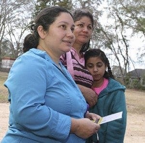 After a brief stopover at El Refugio, Sandra Portillo, foreground, stands with her mother and daughter as they prepare to return to the Charlotte, N.C., area. Portillo and other family members made the six-hour drive to visit her husband, who has been detained at the Stewart Detention Center for a year and a half. Each detainee gets one hour-long visit per week. Photo By Michael Alexander