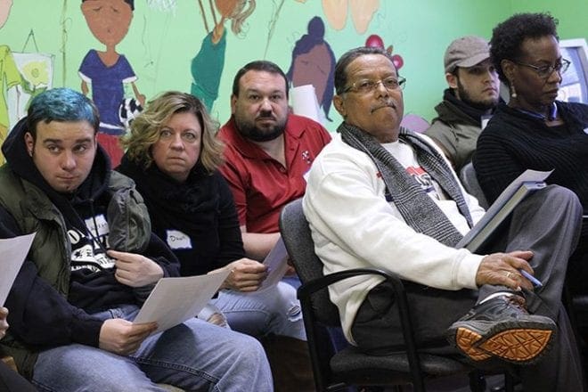 (L-r) Alex Ham-Kucharski of Cumming, a first time attendee along with his mother Dawn and father Rich, Lawrence Soublet, co-founder of the Atlanta chapter of ERACE and a member of Our Lady of Lourdes Church, Atlanta, Luis Perez and Debra Lewis listen as someone makes a comment on the other side of the room. Photo by Michael Alexander