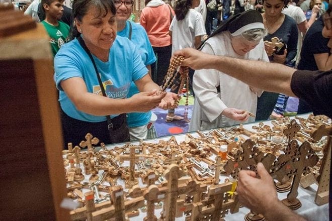 In addition to the experience of seeing the universal Catholic faith in action, Eucharistic Congress attendees had an opportunity to shop in the exhibitor’s hall, where dozens of vendors were selling Catholic products that are spiritual, educational and beautiful in nature, many offering the opportunity to continue studying the faith. Photo By Thomas Spink