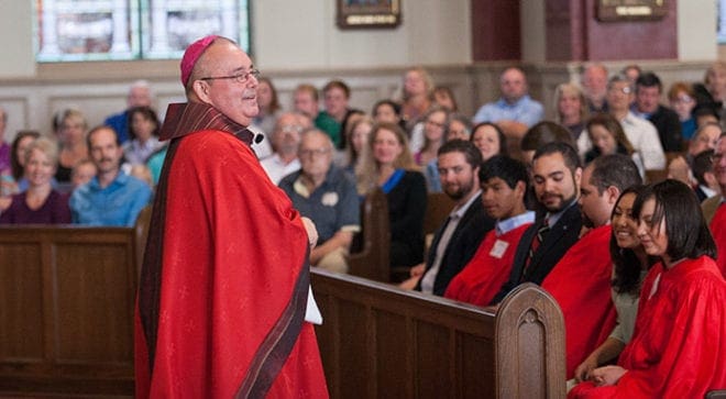 Confirmation candidates and their sponsors listen to encouraging words from Bishop David P. Talley, celebrant of the April 16 confirmation Mass for students with disabilities at St. Brigid Church in Johns Creek. Photo By Thomas Spink