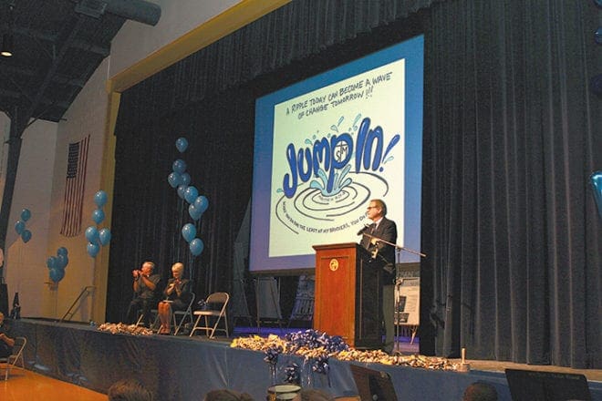 Jerry Raymond, principal of St. Thomas More School, Decatur, makes the Blue Ribbon announcement to the students and faculty of the Decatur school Sept. 28. They previously earned this honor in 1988.