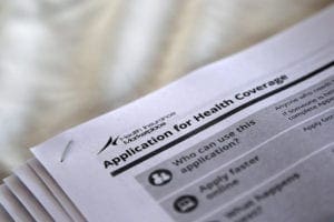 The federal government forms for applying for health coverage are seen at a 2013 rally held by supporters of the Affordable Care Act at a health care center in Jackson, Miss. A poll by Kaiser Family Foundation this summer found that fewer than half of respondents wanted their elected officials to deal with concerns about the Affordable Care Act and one-third wanted it fully repealed.CNS photo/Jonathan Bachman, Reuters 