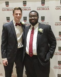 PHOTO BY MELINDA MARTIN Frank Martin ‘13 (left) and Aneek James ‘13 are shown prior to taking the field with the 2016 University of Georgia Homecoming Court. Both men are graduates of St. Pius X High School, Atlanta.