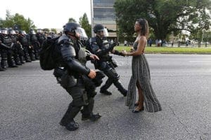 An African-American woman is detained in early July by law enforcement as she protests the fatal shooting of a black man by police near the headquarters of the Baton Rouge Police Department in Louisiana. CNS photo/Jonathan Bachman, Reuters